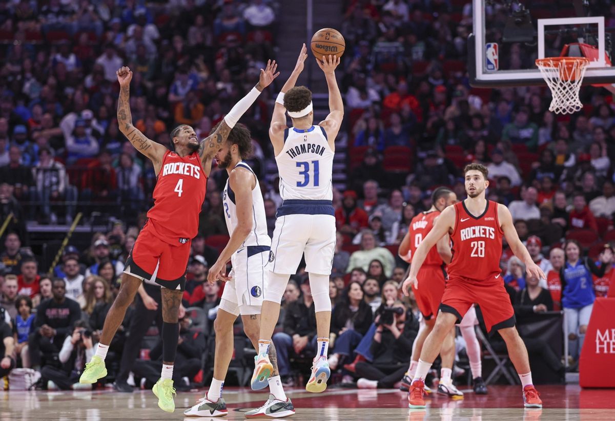 Jan 1, 2025; Houston, Texas, USA; Dallas Mavericks guard Klay Thompson (31) shoots and makes a basket as Houston Rockets guard Jalen Green (4) defends during the first quarter at Toyota Center. Mandatory Credit: Troy Taormina-Imagn Images