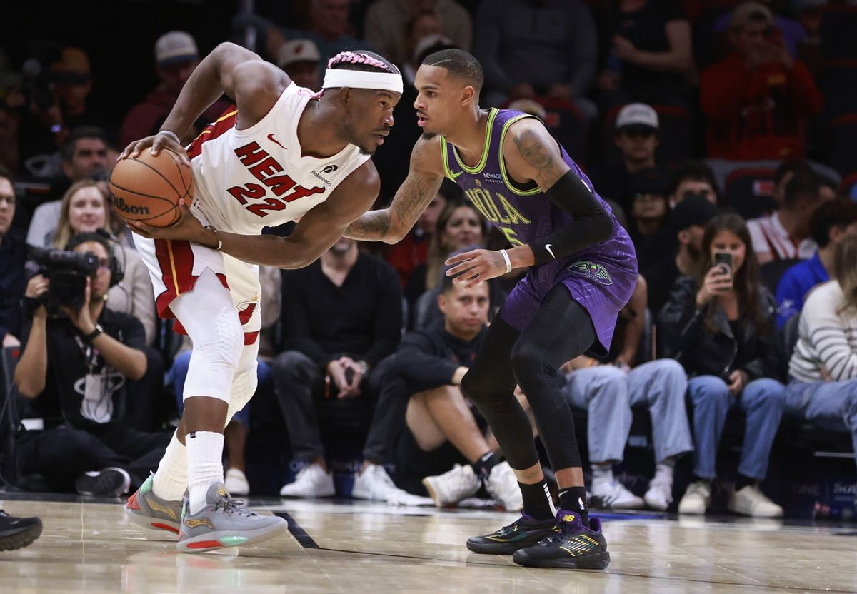 Jan 1, 2025; Miami, Florida, USA;  New Orleans Pelicans guard Dejounte Murray (5) defends Miami Heat forward Jimmy Butler (22) during the first half at Kaseya Center. Mandatory Credit: Rhona Wise-Imagn Images