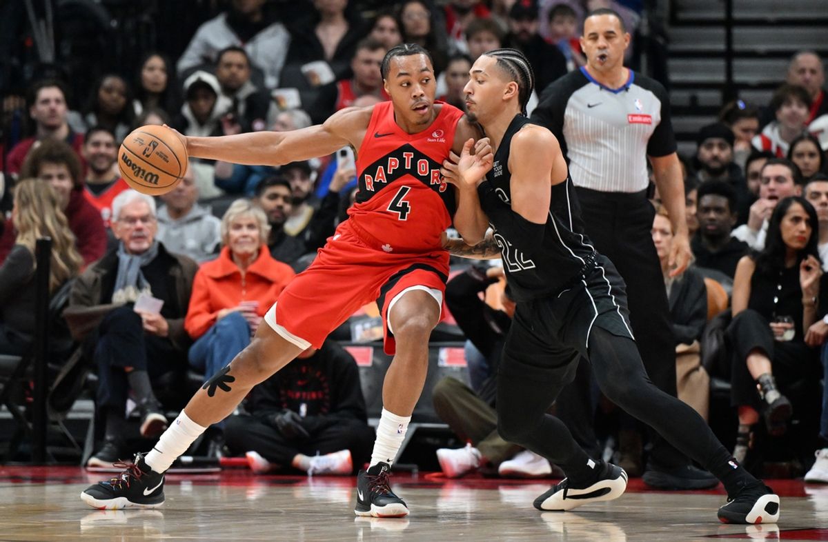Jan 1, 2025; Toronto, Ontario, CAN;  Toronto Raptors forward Scottie Barnes (4) tries to get past Brooklyn Nets forward Jalen Wilson (22) in the first half at Scotiabank Arena. Mandatory Credit: Dan Hamilton-Imagn Images