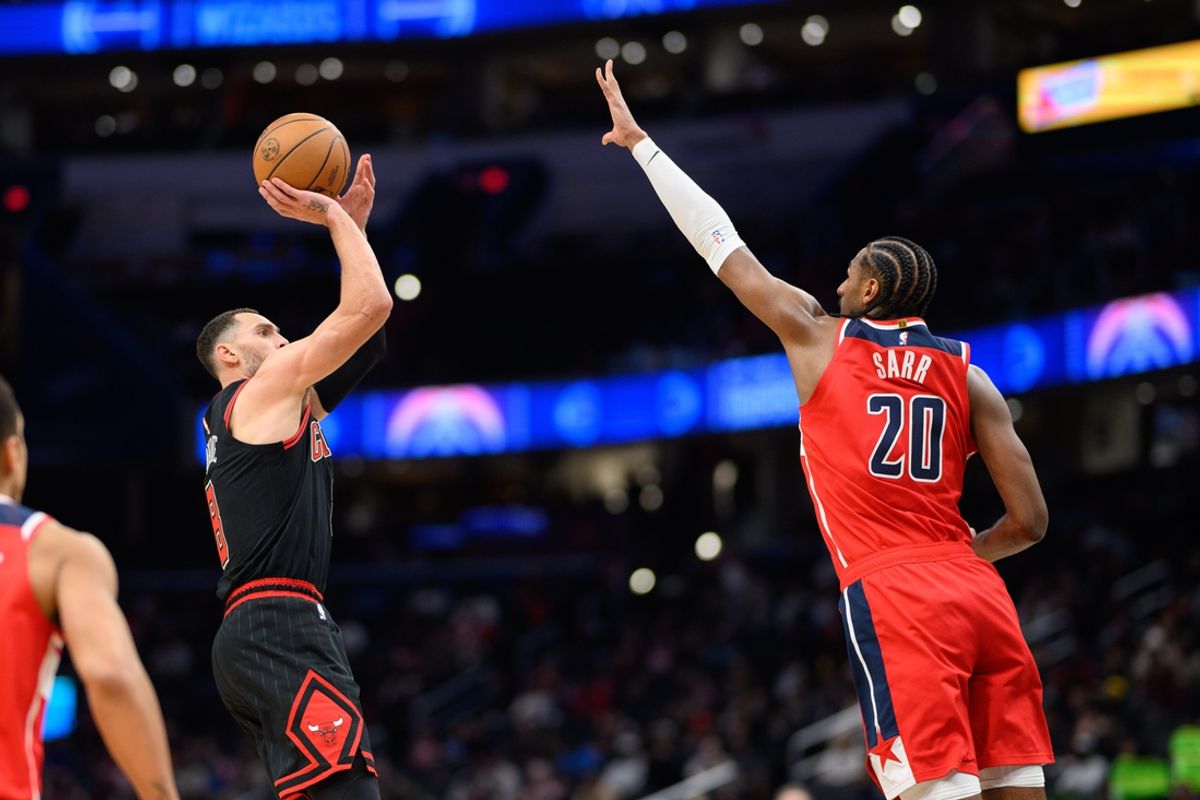 Jan 1, 2025; Washington, District of Columbia, USA; Chicago Bulls guard Zach LaVine (8) takes a jump shot over Washington Wizards forward Alexandre Sarr (20) during the fourth quarter at Capital One Arena. Mandatory Credit: Reggie Hildred-Imagn Images