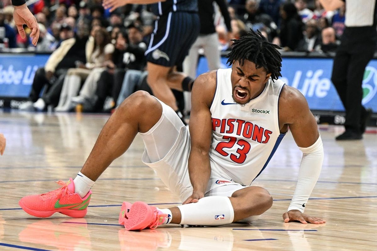 Jan 1, 2025; Detroit, Michigan, USA;  Detroit Pistons guard Jaden Ivey (23) grabs his leg as he falls to the court after being injured against the Orlando Magic in the fourth quarter at Little Caesars Arena. Mandatory Credit: Lon Horwedel-Imagn Images