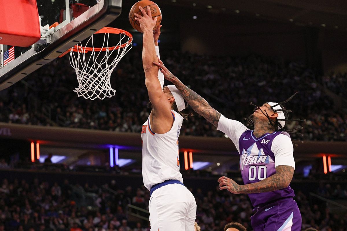 Jan 1, 2025; New York, New York, USA; New York Knicks guard Josh Hart (3) goes up for a dunk as Utah Jazz guard Jordan Clarkson (00) defends during the second half at Madison Square Garden. Mandatory Credit: Vincent Carchietta-Imagn Images