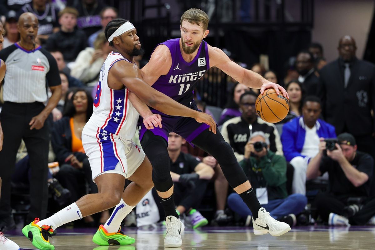Jan 1, 2025; Sacramento, California, USA; Sacramento Kings forward Domantas Sabonis (11) controls the ball against Philadelphia 76ers forward Guerschon Yabusele (28) during the first quarter at Golden 1 Center. Mandatory Credit: Sergio Estrada-Imagn Images