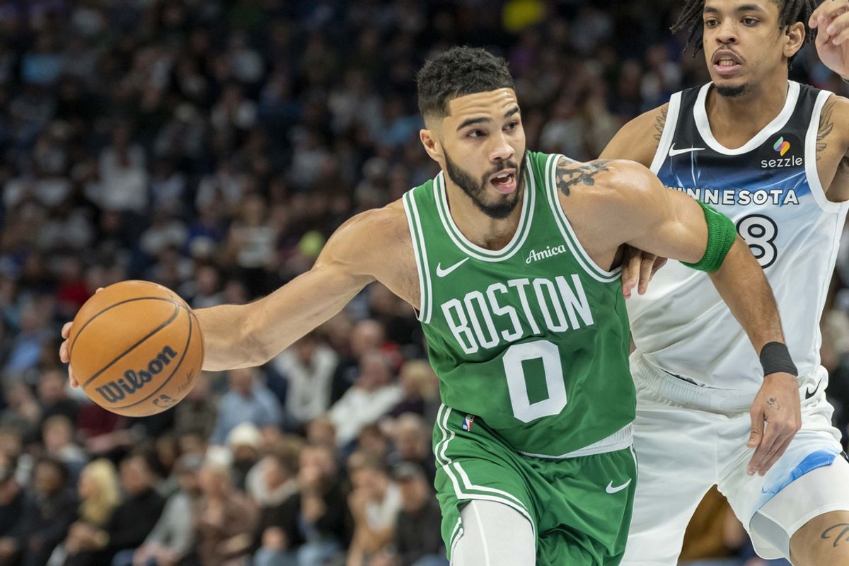 Jan 2, 2025; Minneapolis, Minnesota, USA; Boston Celtics forward Jayson Tatum (0) drives past Minnesota Timberwolves forward Josh Minott (8) in the first half at Target Center. Mandatory Credit: Jesse Johnson-Imagn Images
