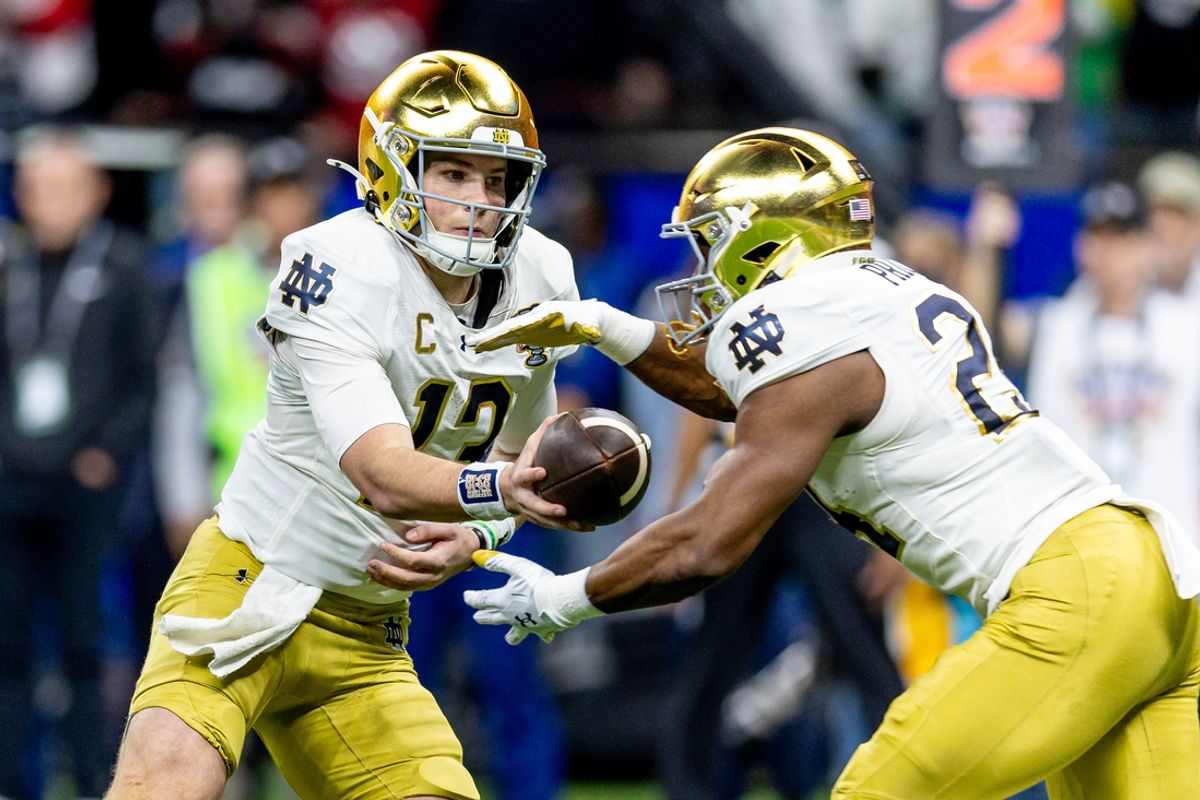 Jan 2, 2025; New Orleans, LA, USA;  Notre Dame Fighting Irish quarterback Riley Leonard (13) hands off to Notre Dame Fighting Irish running back Jadarian Price (24) on a run against the Georgia Bulldogs during the second half at Caesars Superdome. Mandatory Credit: Stephen Lew-Imagn Images