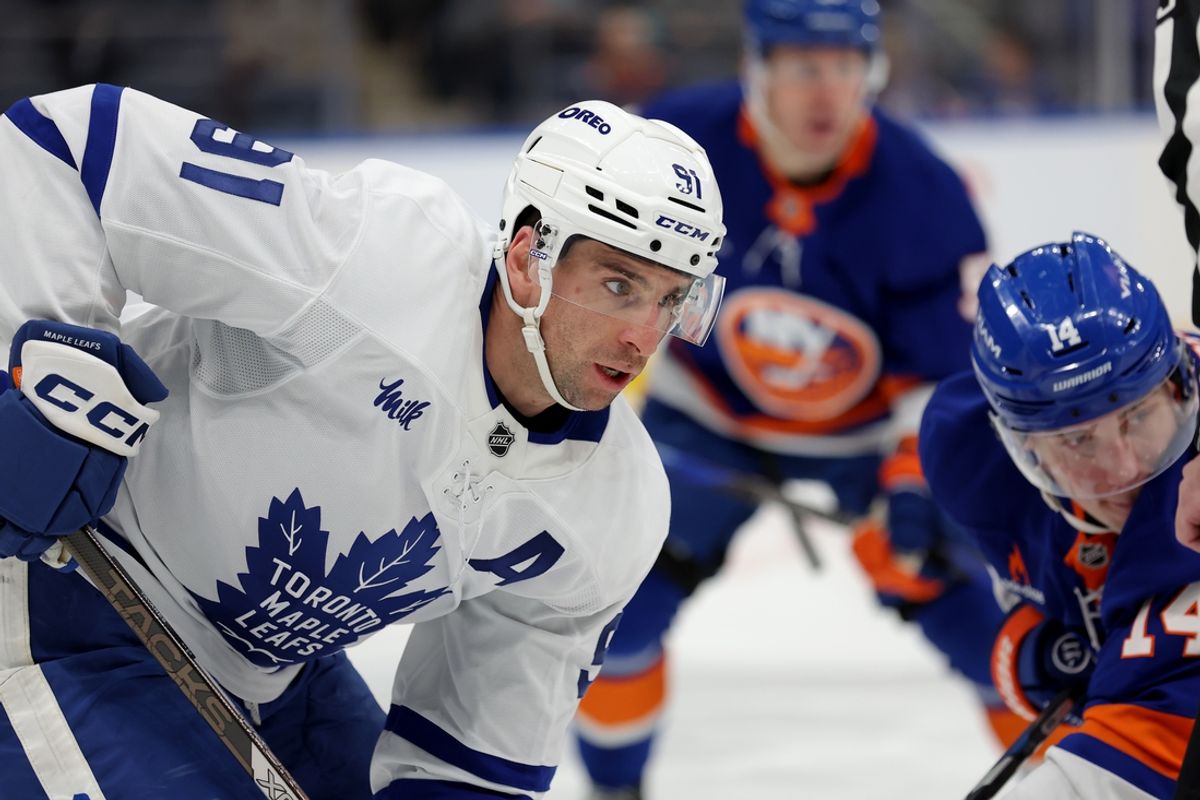 Jan 2, 2025; Elmont, New York, USA; Toronto Maple Leafs center John Tavares (91) takes a face-off against New York Islanders center Bo Horvat (14) during the second period at UBS Arena. Mandatory Credit: Brad Penner-Imagn Images