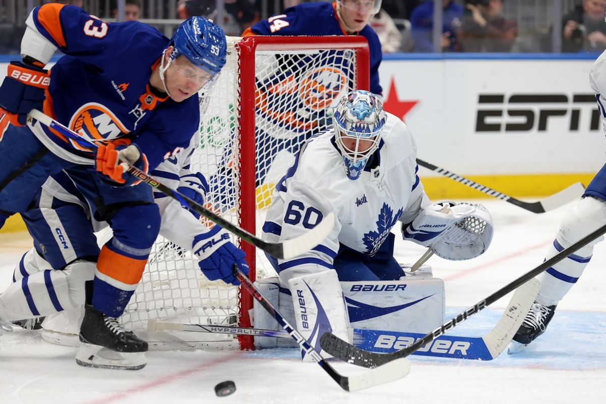 Jan 2, 2025; Elmont, New York, USA; Toronto Maple Leafs goaltender Joseph Woll (60) makes a save against New York Islanders center Casey Cizikas (53) during the second period at UBS Arena. Mandatory Credit: Brad Penner-Imagn Images