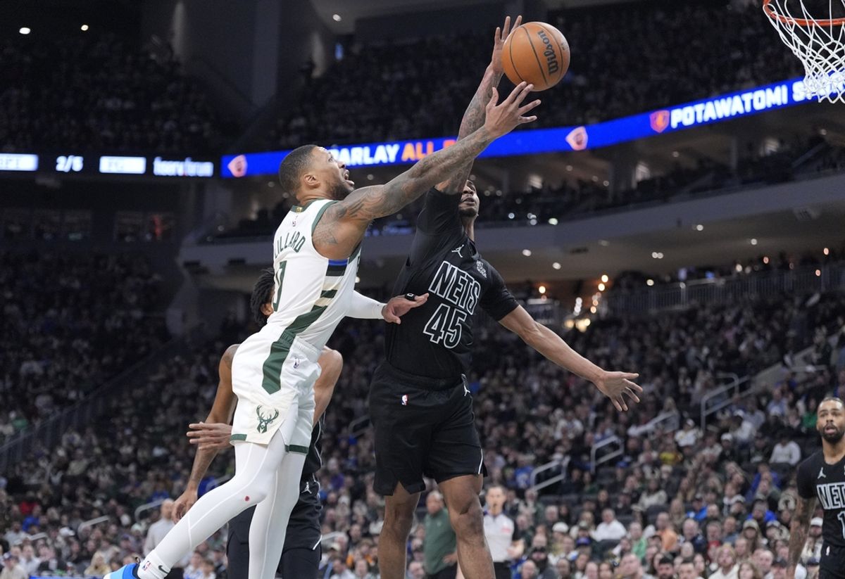 Jan 2, 2025; Milwaukee, Wisconsin, USA; Milwaukee Bucks guard Damian Lillard (0) drives to the basket against Brooklyn Nets guard Keon Johnson (45) in the first halfat Fiserv Forum. Mandatory Credit: Michael McLoone-Imagn Images