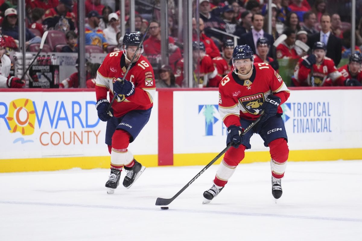 Jan 2, 2025; Sunrise, Florida, USA; Florida Panthers center Sam Reinhart (13) looks to pass the puck against the Carolina Hurricanes during the third period at Amerant Bank Arena. Mandatory Credit: Rich Storry-Imagn Images