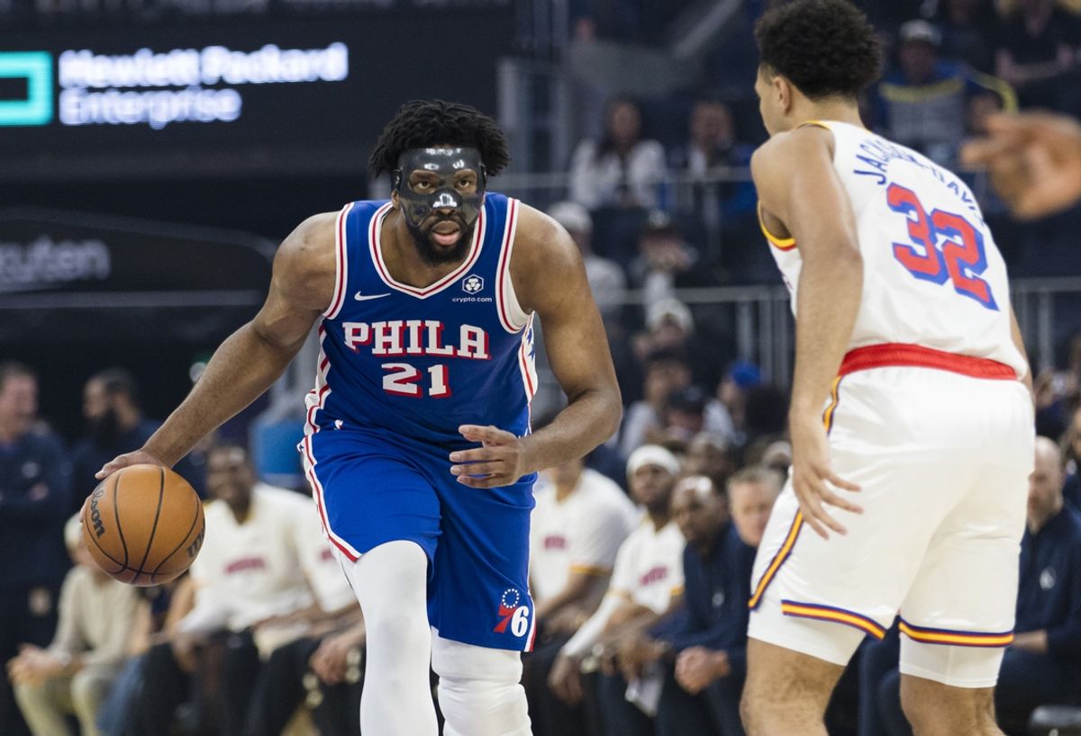 Jan 2, 2025; San Francisco, California, USA; Philadelphia 76ers center Joel Embiid (21) drives past Golden State Warriors forward Trayce Jackson-Davis (32) during the first quarter at Chase Center. Mandatory Credit: John Hefti-Imagn Images