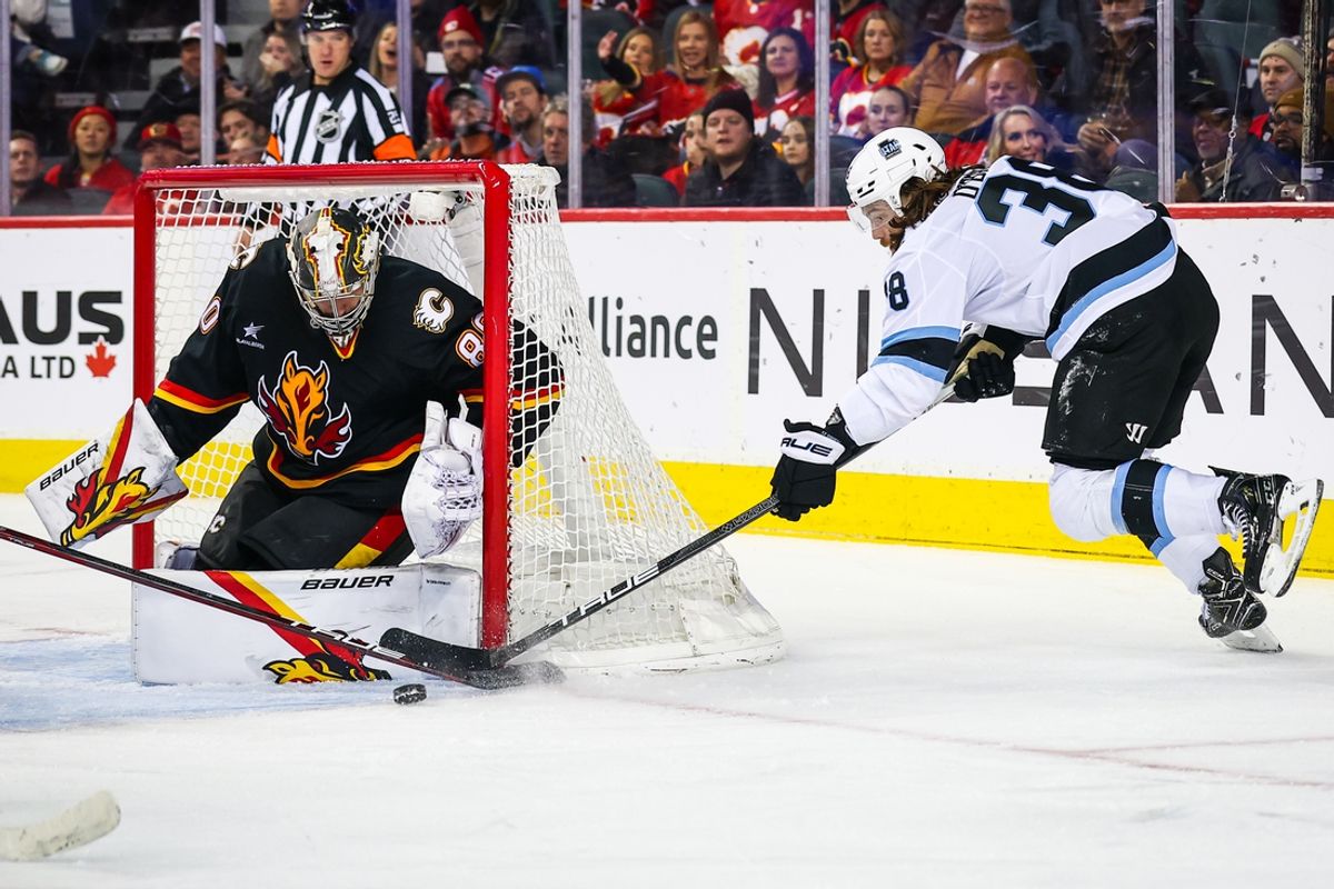 Jan 2, 2025; Calgary, Alberta, CAN; Calgary Flames goaltender Dan Vladar (80) guards his net against Utah Hockey Club center Liam O'Brien (38) during the second period at Scotiabank Saddledome. Mandatory Credit: Sergei Belski-Imagn Images