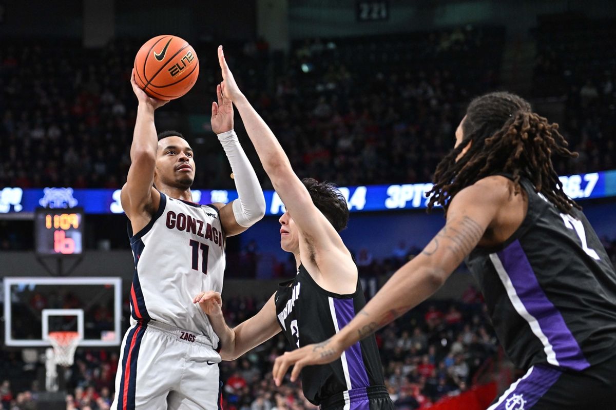 Jan 2, 2025; Spokane, Washington, USA; Gonzaga Bulldogs guard Nolan Hickman (11) shoots against Portland Pilots guard Max Mackinnon (3) in the second half at Spokane Veterans Memorial Arena. Mandatory Credit: James Snook-Imagn Images