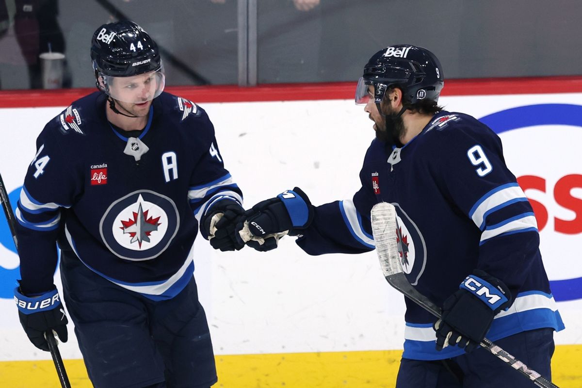 Jan 2, 2025; Winnipeg, Manitoba, CAN; Winnipeg Jets left wing Alex Iafallo (9) celebrates his third period goal with Winnipeg Jets defenseman Josh Morrissey (44) against the Anaheim Ducks at Canada Life Centre. Mandatory Credit: James Carey Lauder-Imagn Images