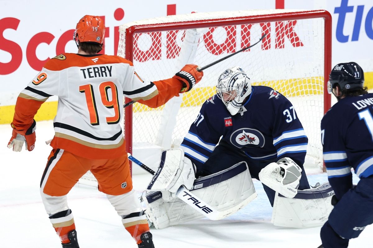 Jan 2, 2025; Winnipeg, Manitoba, CAN; Anaheim Ducks right wing Troy Terry (19) celebrates his overtime goal against Winnipeg Jets goaltender Connor Hellebuyck (37) at Canada Life Centre. Mandatory Credit: James Carey Lauder-Imagn Images