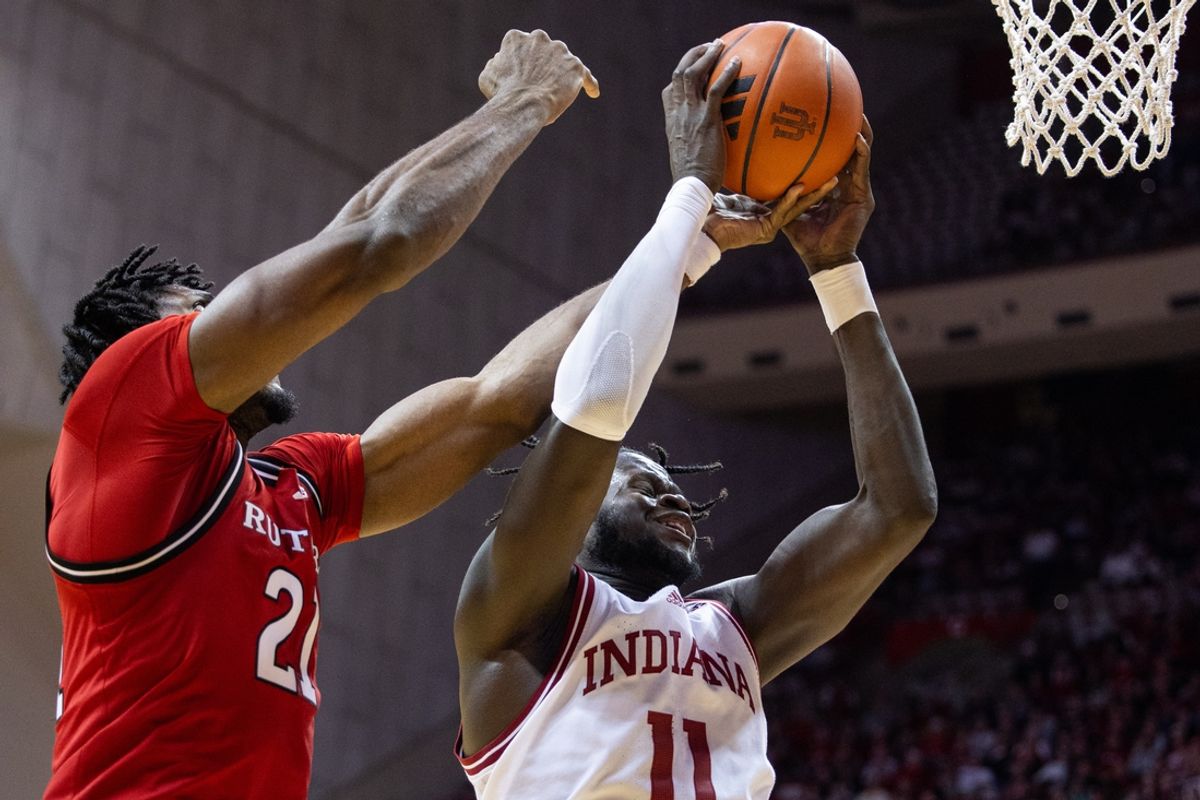 Jan 2, 2025; Bloomington, Indiana, USA; Rutgers Scarlet Knights center Emmanuel Ogbole (21) and Indiana Hoosiers center Oumar Ballo (11) fight for a rebound in the second half at Simon Skjodt Assembly Hall. Mandatory Credit: Trevor Ruszkowski-Imagn Images