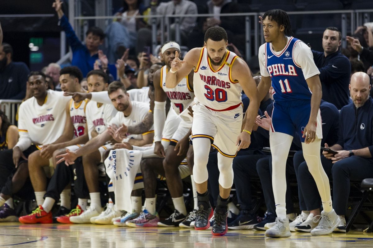 Jan 2, 2025; San Francisco, California, USA; Golden State Warriors guard Stephen Curry (30) reacts in front of the bench after hitting a three-point shot against the Philadelphia 76ers during the second quarter at Chase Center. Mandatory Credit: John Hefti-Imagn Images