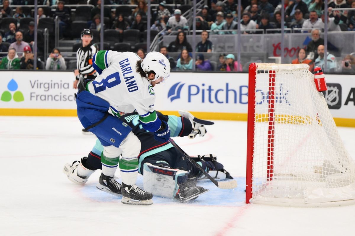 Jan 2, 2025; Seattle, Washington, USA; Vancouver Canucks right wing Conor Garland (8) shoots and scores a goal past Seattle Kraken goaltender Philipp Grubauer (31) during the second period at Climate Pledge Arena. Mandatory Credit: Steven Bisig-Imagn Images