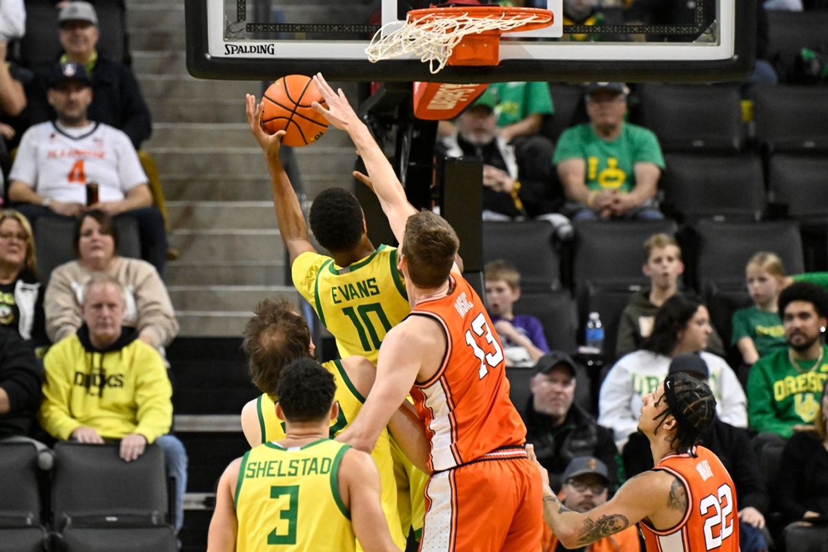 Jan 2, 2025; Eugene, Oregon, USA; Oregon Ducks forward Kwame Evans Jr. (10) has his shot blocked by Illinois Fighting Illini center Tomislav Ivisic (13) during the second half at Matthew Knight Arena. Mandatory Credit: Craig Strobeck-Imagn Images