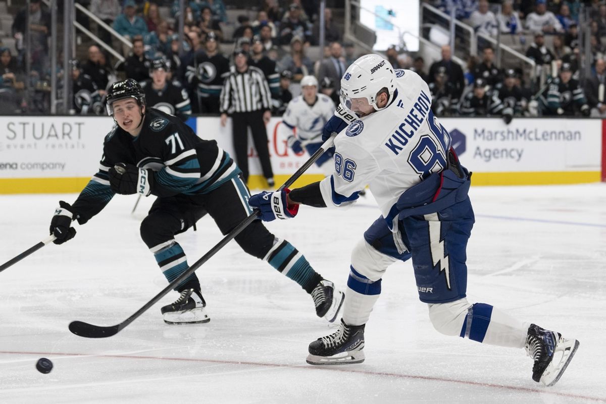 Jan 2, 2025; San Jose, California, USA;  Tampa Bay Lightning right wing Nikita Kucherov (86) shoots the puck during the third period against San Jose Sharks center Macklin Celebrini (71) at SAP Center at San Jose. Mandatory Credit: Stan Szeto-Imagn Images