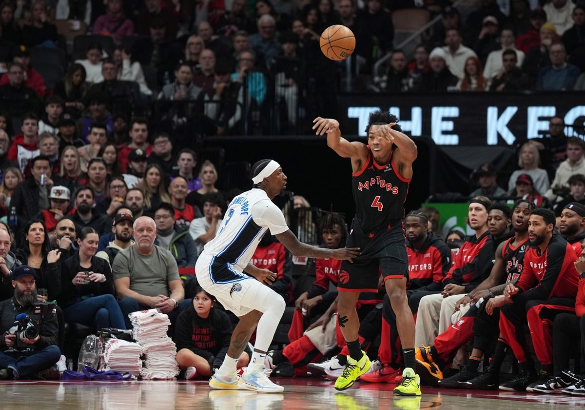 Jan 3, 2025; Toronto, Ontario, CAN: Toronto Raptors forward Scottie Barnes (4) passes against Orlando Magic guard Kentavious Caldwell-Pope (3) during the first quarter at Scotiabank Arena.. Mandatory Credit: Nick Turchiaro-Imagn Images