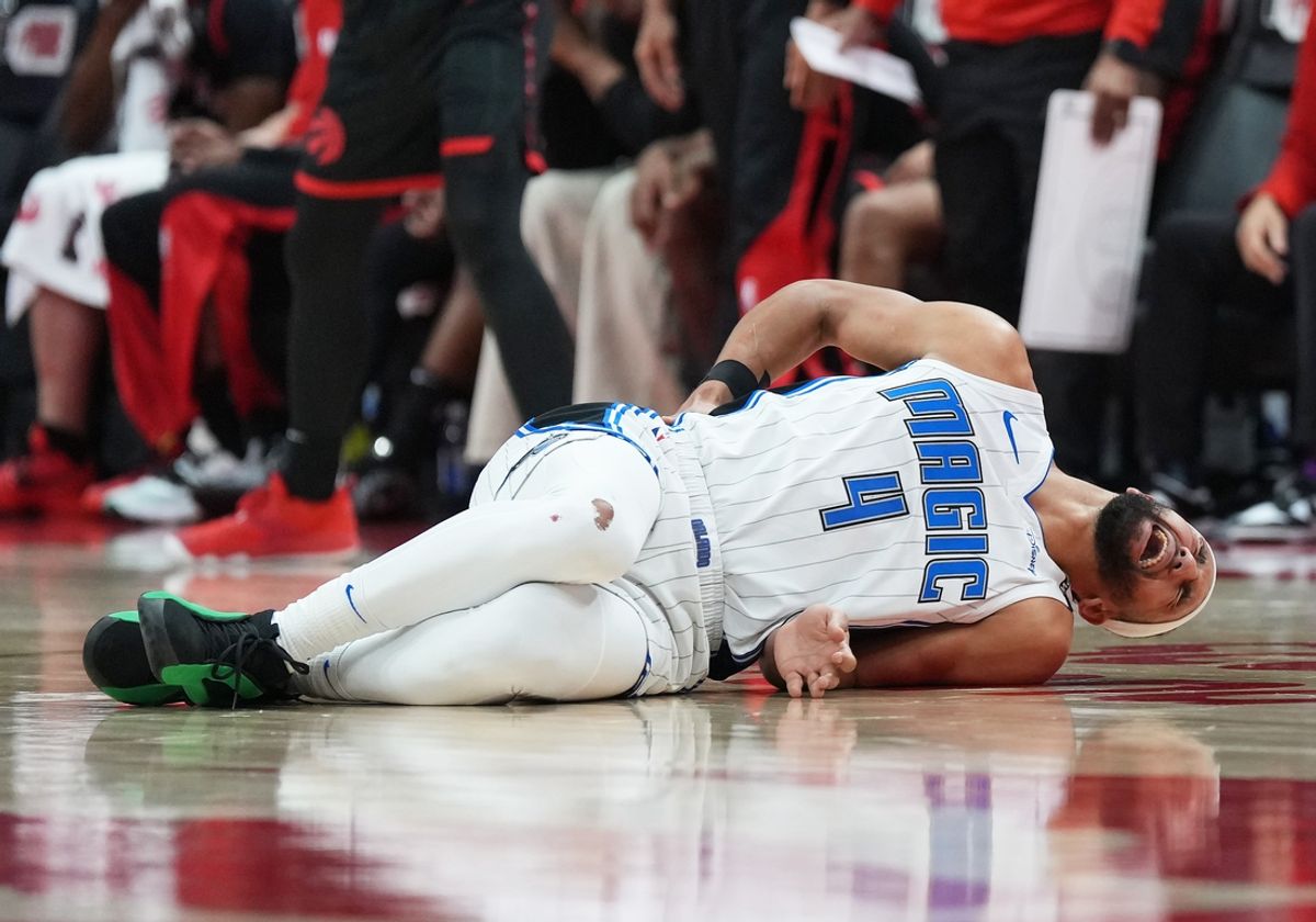 Jan 3, 2025; Toronto, Ontario, CAN: Orlando Magic guard Jalen Suggs (4) lays on the court after being injured against the Toronto Raptors during the second quarter at Scotiabank Arena.. Mandatory Credit: Nick Turchiaro-Imagn Images