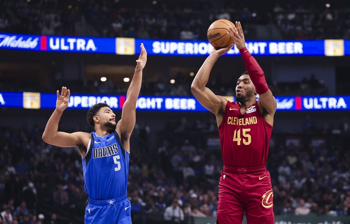 Jan 3, 2025; Dallas, Texas, USA;  Cleveland Cavaliers guard Donovan Mitchell (45) shoots over Dallas Mavericks guard Quentin Grimes (5) during the first quarter at American Airlines Center. Mandatory Credit: Kevin Jairaj-Imagn Images