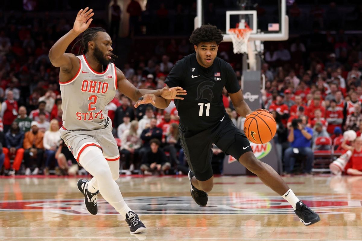 Jan 3, 2025; Columbus, Ohio, USA;  Michigan State Spartans guard Jase Richardson (11) dribbles past Ohio State Buckeyes guard Bruce Thornton (2) during the first half at Value City Arena. Mandatory Credit: Joseph Maiorana-Imagn Images