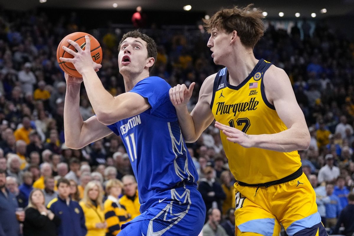 Jan 3, 2025; Milwaukee, Wisconsin, USA;  Creighton Bluejays center Ryan Kalkbrenner (11) looks to shoot around Marquette Golden Eagles forward Ben Gold (12) during the first half at Fiserv Forum. Mandatory Credit: Jeff Hanisch-Imagn Images