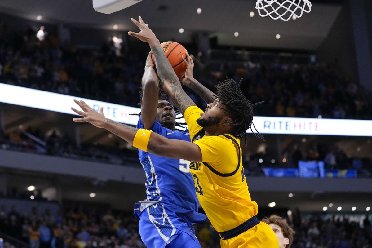 Jan 3, 2025; Milwaukee, Wisconsin, USA;  Creighton Bluejays guard-forward Jamiya Neal (5) shoots against Marquette Golden Eagles forward David Joplin (23) during the first half at Fiserv Forum. Mandatory Credit: Jeff Hanisch-Imagn Images