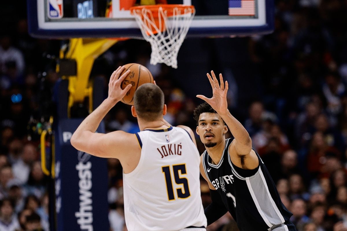 Jan 3, 2025; Denver, Colorado, USA; Denver Nuggets center Nikola Jokic (15) attempts a shot against San Antonio Spurs center Victor Wembanyama (1) in the second quarter at Ball Arena. Mandatory Credit: Isaiah J. Downing-Imagn Images