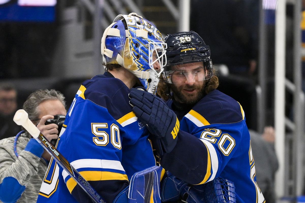 Jan 3, 2025; St. Louis, Missouri, USA;  St. Louis Blues left wing Brandon Saad (20) and goaltender Jordan Binnington (50) celebrate after the Blues defeated the Ottawa Senators at Enterprise Center. Mandatory Credit: Jeff Curry-Imagn Images
