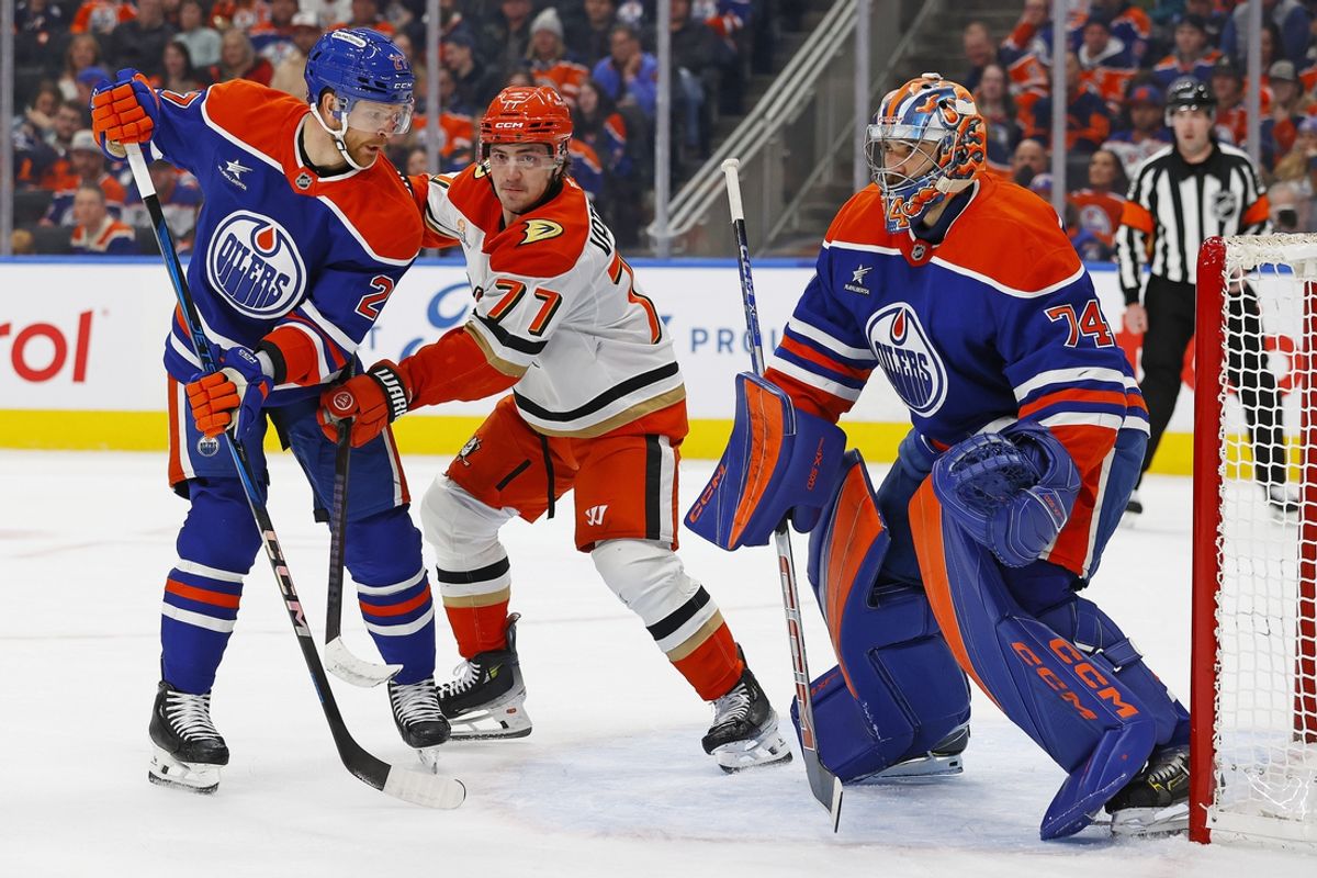 Jan 3, 2025; Edmonton, Alberta, CAN; Anaheim Ducks forward Frank Vatrano (77) battles for position with Edmonton Oilers defensemen Brett Kulak (27) in front of goaltender Stuart Skinner (74) during the second period at Rogers Place. Mandatory Credit: Perry Nelson-Imagn Images