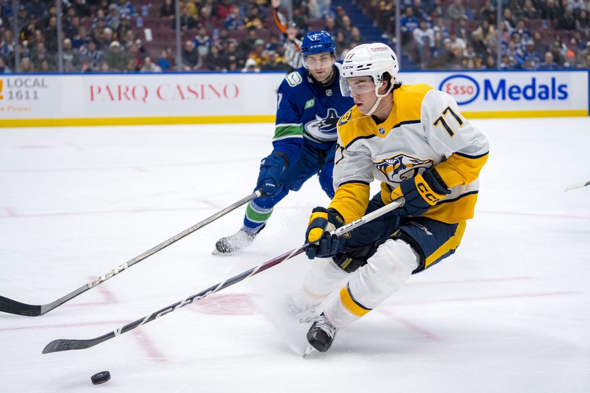 Jan 3, 2025; Vancouver, British Columbia, CAN; Vancouver Canucks defenseman Carson Soucy (7) defends against Nashville Predators forward Luke Evangelista (77) in the third period at Rogers Arena. Mandatory Credit: Bob Frid-Imagn Images