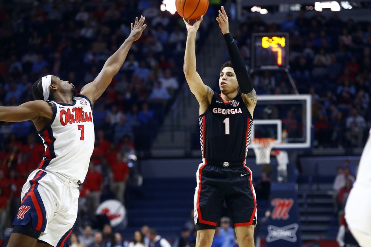 Jan 4, 2025; Oxford, Mississippi, USA; Georgia Bulldogs guard Dakota Leffew (1) shoots for three as Mississippi Rebels guard Davon Barnes (7) defends during the first half at The Sandy and John Black Pavilion at Ole Miss. Mandatory Credit: Petre Thomas-Imagn Images