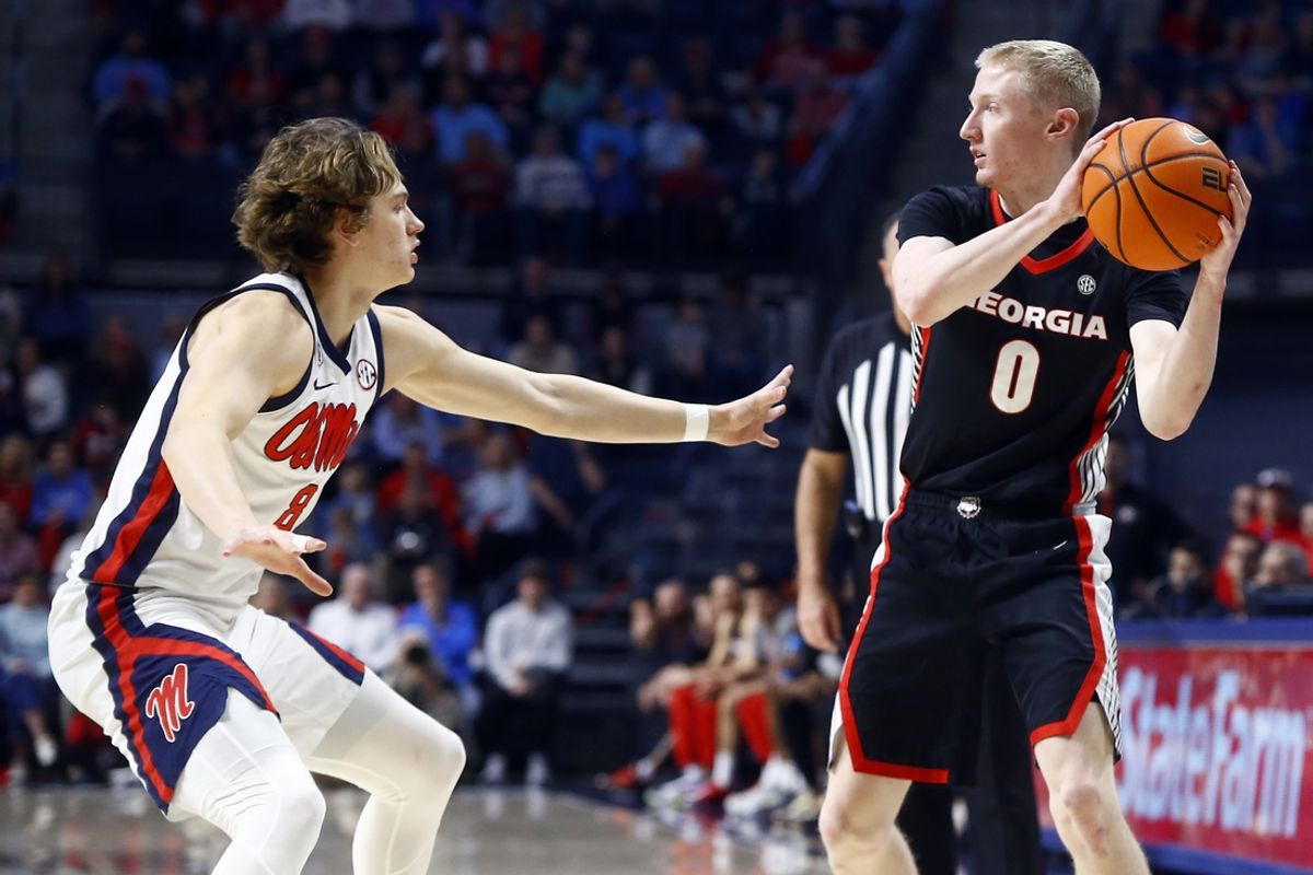 Jan 4, 2025; Oxford, Mississippi, USA; Georgia Bulldogs guard Blue Cain (0) handles the ball as Mississippi Rebels guard Eduardo Klafke (8) defends during the first half at The Sandy and John Black Pavilion at Ole Miss. Mandatory Credit: Petre Thomas-Imagn Images