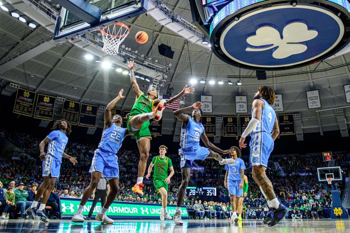 Jan 4, 2025; South Bend, Indiana, USA; Notre Dame Fighting Irish forward Tae Davis (7) is fouled by North Carolina Tar Heels guard Drake Powell (9) in the first half at the Purcell Pavilion. Mandatory Credit: Matt Cashore-Imagn Images