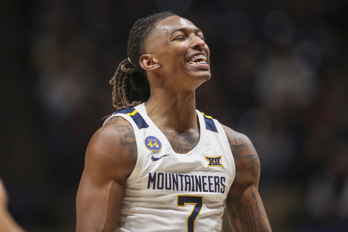 Jan 4, 2025; Morgantown, West Virginia, USA; West Virginia Mountaineers guard Javon Small (7) celebrates during the first half against the Oklahoma State Cowboys at WVU Coliseum. Mandatory Credit: Ben Queen-Imagn Images