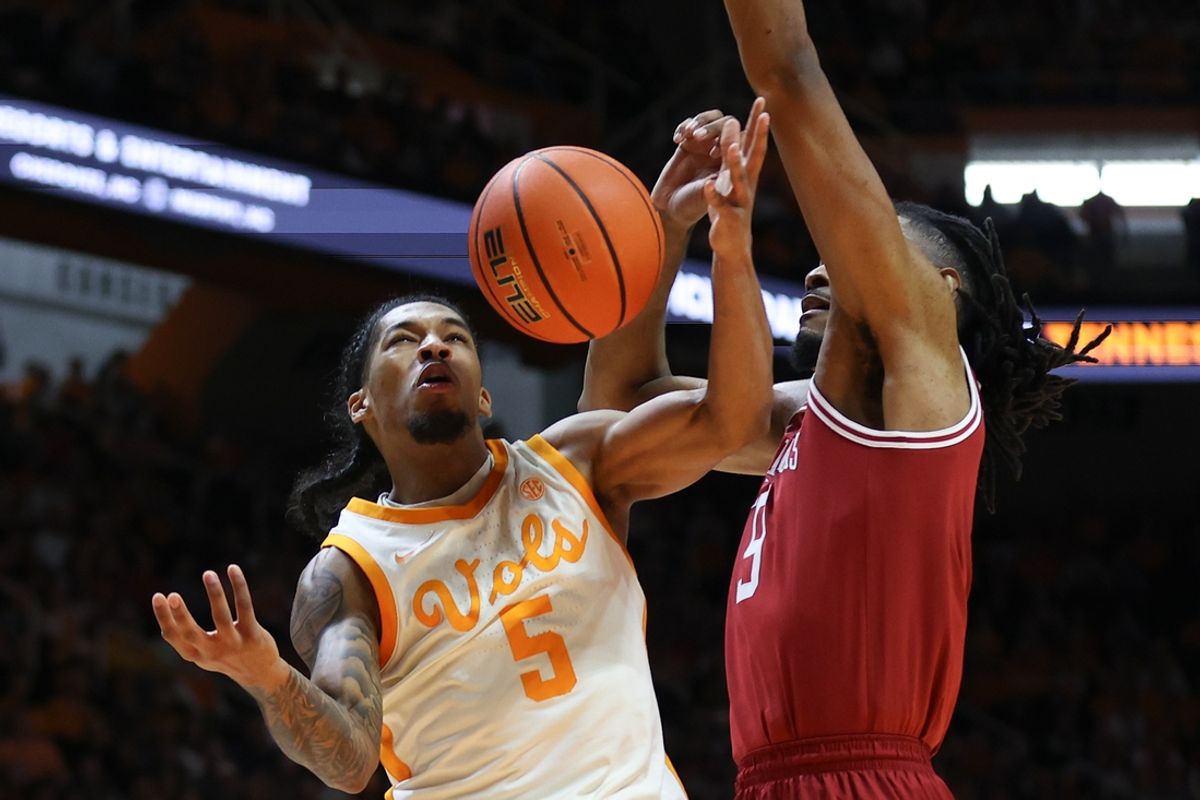 Jan 4, 2025; Knoxville, Tennessee, USA; Tennessee Volunteers guard Zakai Zeigler (5) is fouled by former Tennessee Volunteer and current Arkansas Razorbacks forward Jonas Aidoo (9) during the first half at Thompson-Boling Arena at Food City Center. Mandatory Credit: Randy Sartin-Imagn Images