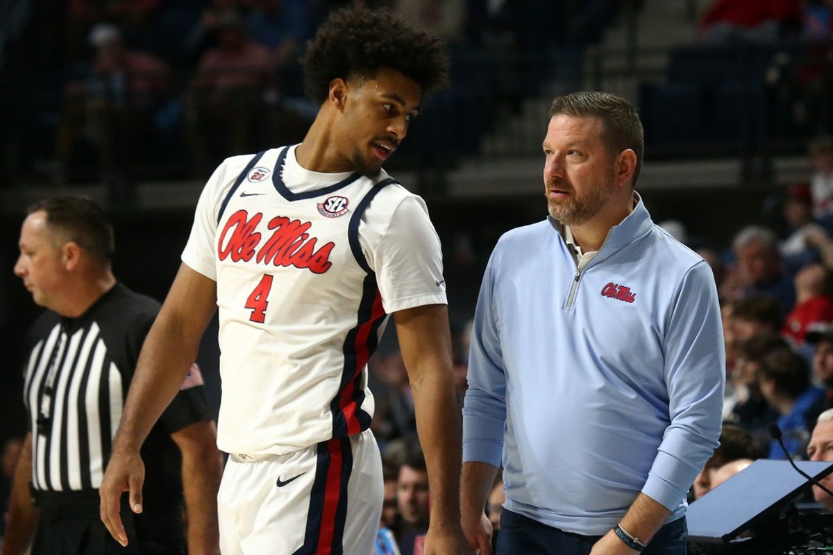Jan 4, 2025; Oxford, Mississippi, USA; Mississippi Rebels head coach Chris Beard (right) talks with forward Jaemyn Brakefield (4) during the second half against the Georgia Bulldogs at The Sandy and John Black Pavilion at Ole Miss. Mandatory Credit: Petre Thomas-Imagn Images