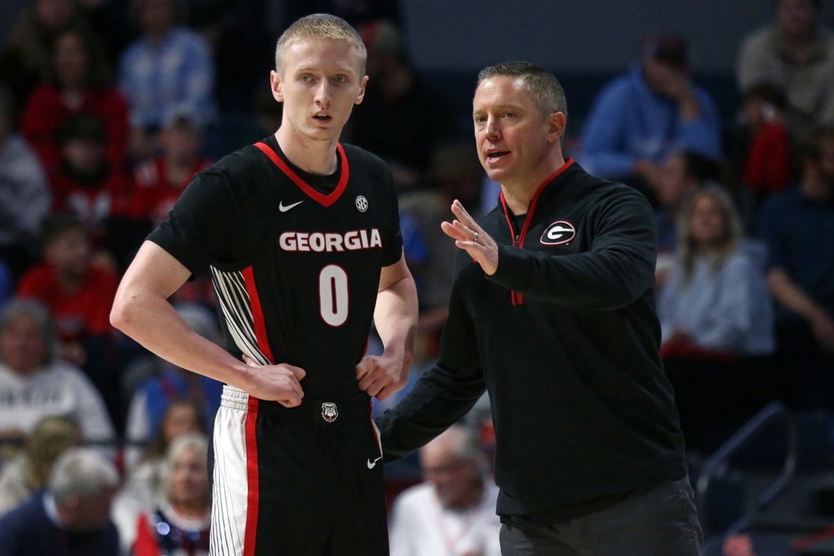 Jan 4, 2025; Oxford, Mississippi, USA; Georgia Bulldogs head coach Mike White (right) talks with guard Blue Cain (0) during the second half against the Mississippi Rebels at The Sandy and John Black Pavilion at Ole Miss. Mandatory Credit: Petre Thomas-Imagn Images