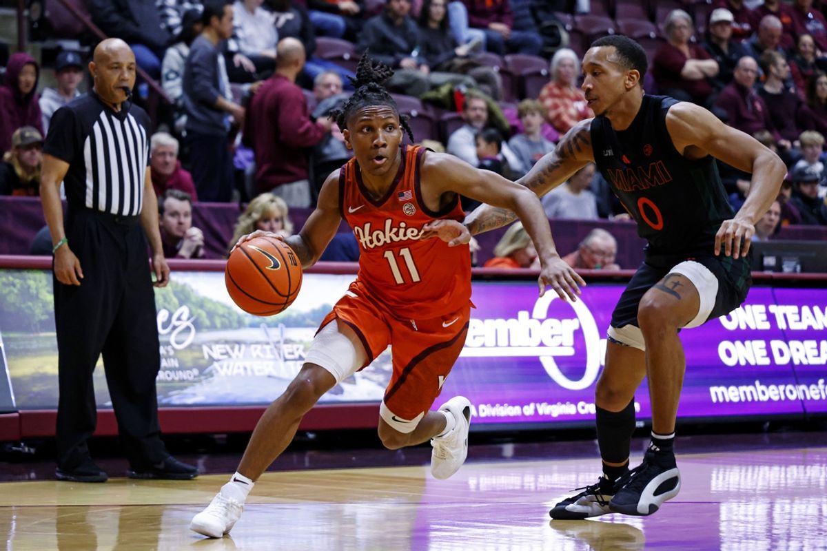 Jan 4, 2025; Blacksburg, Virginia, USA; Virginia Tech Hokies guard Ben Hammond (11) drives to the basket against Miami Hurricanes guard Matthew Cleveland (0) during the first half at Cassell Coliseum. Mandatory Credit: Peter Casey-Imagn Images