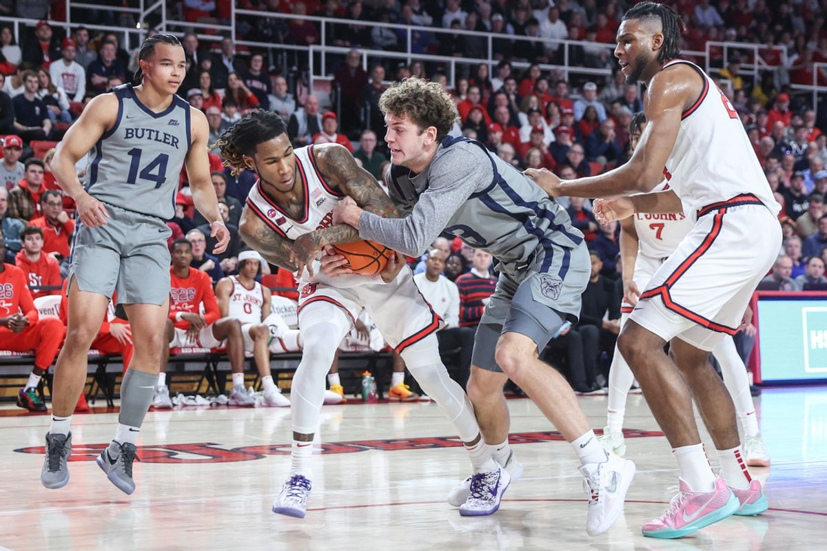 Jan 4, 2025; Queens, New York, USA;  St. John's Red Storm guard Deivon Smith (5) and Butler Bulldogs guard Finley Bizjack (13) fight for a loose ball in the first half at Carnesecca Arena. Mandatory Credit: Wendell Cruz-Imagn Images
