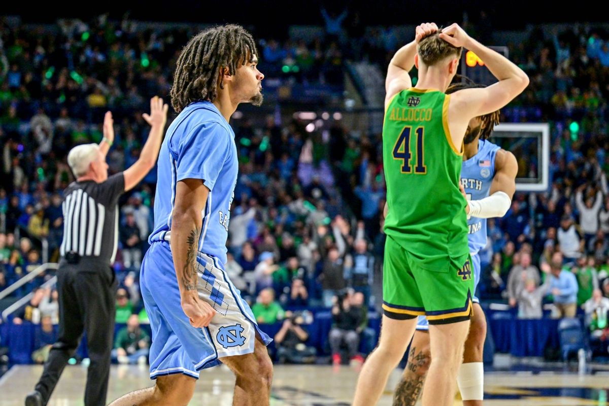 Jan 4, 2025; South Bend, Indiana, USA; North Carolina Tar Heels guard Elliot Cadeau (3) and Notre Dame Fighting Irish guard Matt Allocco (41) react after Nadeau was fouled by Allocco on a three-point basket at the end of the second half at the Purcell Pavilion. Mandatory Credit: Matt Cashore-Imagn Images
