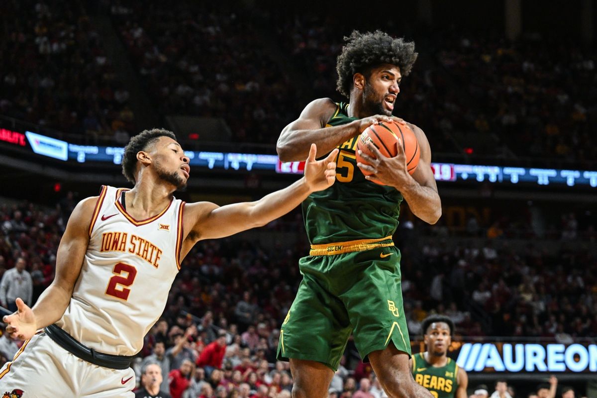 Jan 4, 2025; Ames, Iowa, USA; Baylor Bears forward Norchad Omier (15) gathers the rebound as Iowa State Cyclones forward Joshua Jefferson (2) defends during the first half at James H. Hilton Coliseum. Mandatory Credit: Jeffrey Becker-Imagn Images