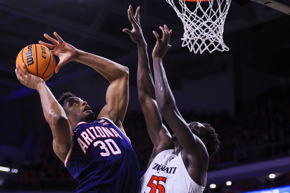 Jan 4, 2025; Cincinnati, Ohio, USA; Arizona Wildcats forward Tobe Awaka (30) shoots against Cincinnati Bearcats forward Aziz Bandaogo (55) in the first half at Fifth Third Arena. Mandatory Credit: Katie Stratman-Imagn Images