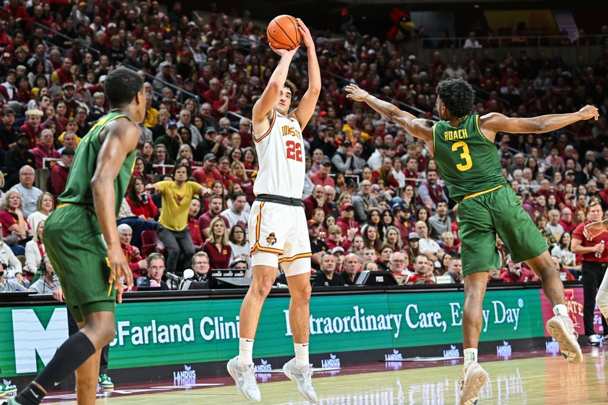 Jan 4, 2025; Ames, Iowa, USA; Iowa State Cyclones forward Milan Momcilovic (22) shoots a three-point basket as Baylor Bears guard Jeremy Roach (3) defends during the first half at James H. Hilton Coliseum. Mandatory Credit: Jeffrey Becker-Imagn Images