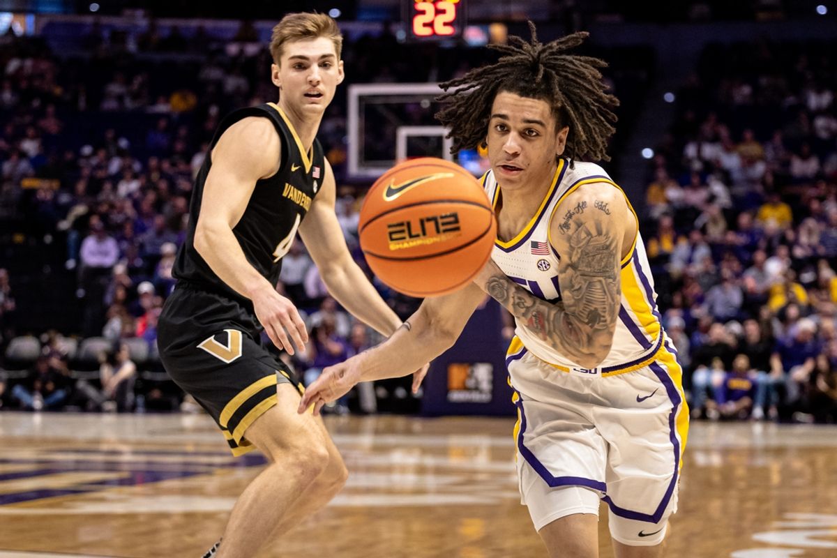Jan 4, 2025; Baton Rouge, Louisiana, USA;  LSU Tigers guard Dji Bailey (4) and Vanderbilt Commodores guard Grant Huffman (4) go for a loose ball during the first half at Pete Maravich Assembly Center. Mandatory Credit: Stephen Lew-Imagn Images