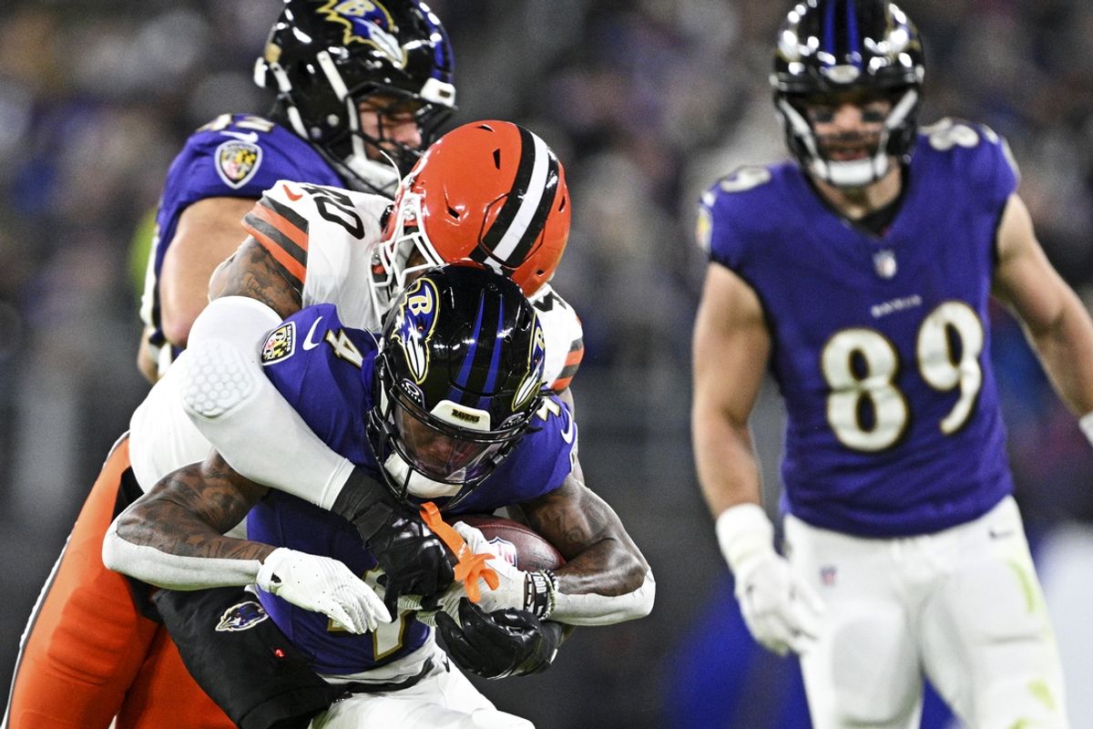 Jan 4, 2025; Baltimore, Maryland, USA; Baltimore Ravens wide receiver Zay Flowers (4) is tackled by Cleveland Browns linebacker Nathaniel Watson (40) during the second quarter at M&T Bank Stadium. Mandatory Credit: Tommy Gilligan-Imagn Images