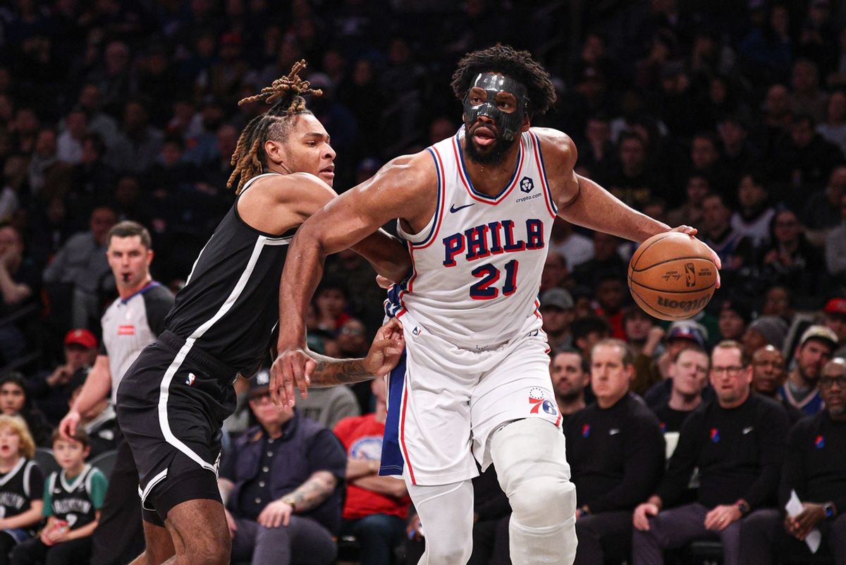 Jan 4, 2025; Brooklyn, New York, USA; Philadelphia 76ers center Joel Embiid (21) is guarded by Brooklyn Nets forward Noah Clowney (21) during the first half at Barclays Center. Mandatory Credit: Vincent Carchietta-Imagn Images