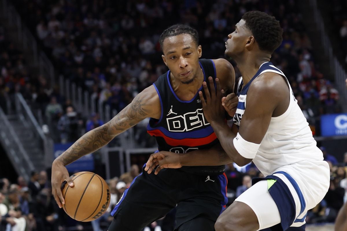 Jan 4, 2025; Detroit, Michigan, USA;  Detroit Pistons forward Ronald Holland II (00) dribbles defended by Minnesota Timberwolves guard Anthony Edwards (5) in the first half t Little Caesars Arena. Mandatory Credit: Rick Osentoski-Imagn Images